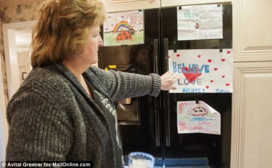 Memories: Linda Pelletier points to art on the family's refrigerator drawn by Justina while she's been in hospital